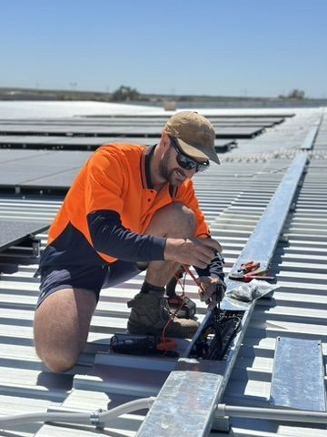 A Charge On Electrical electrician wiring a commercial solar array