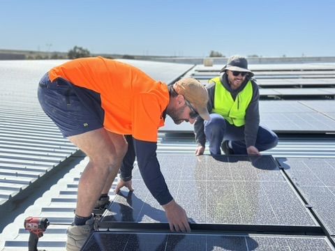 The Charge On Electrical team fitting panels on a commercial solar job